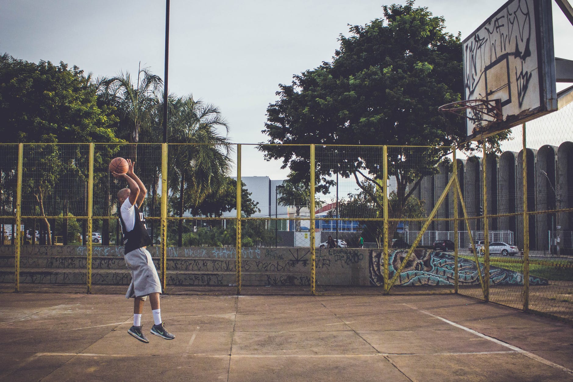Play Basketball - Basketball Player Jumping with the Ball